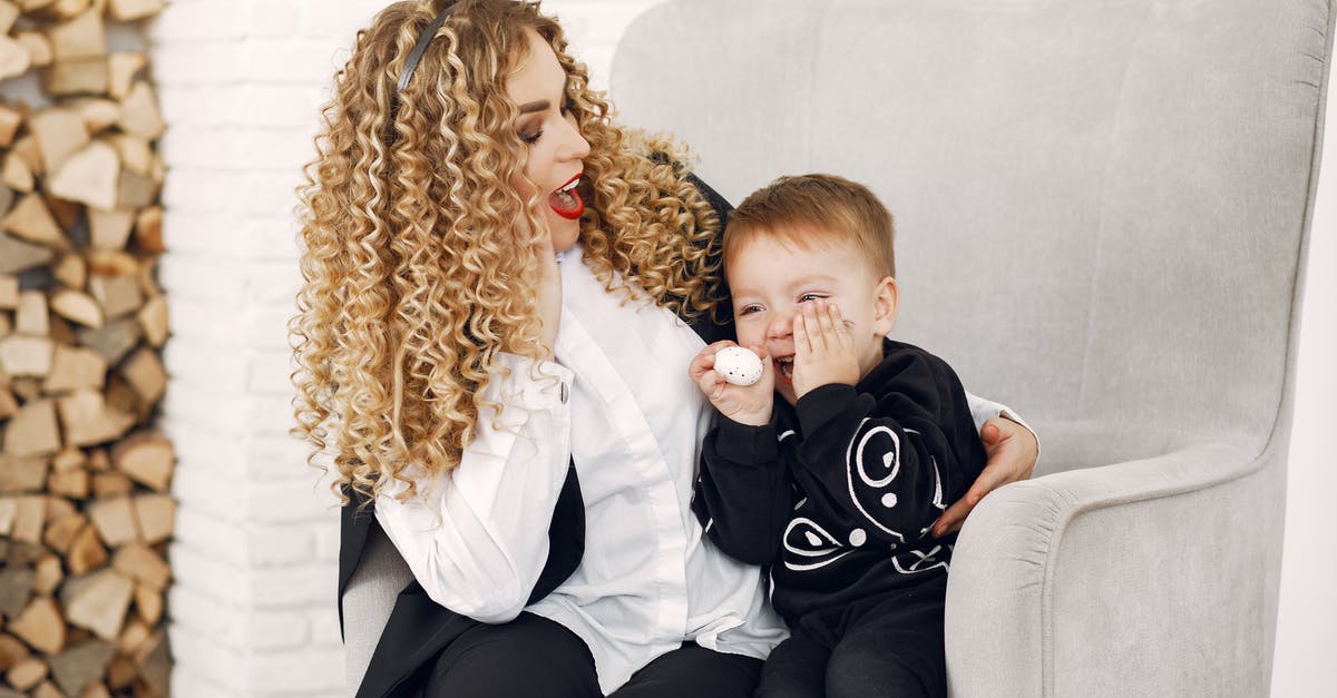 Optimal egg size? - Mother and Son Sitting on Armchair