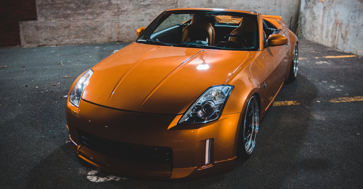 Orange spots on dry chickpea - Colorful modern sports car on asphalt pavement at dusk