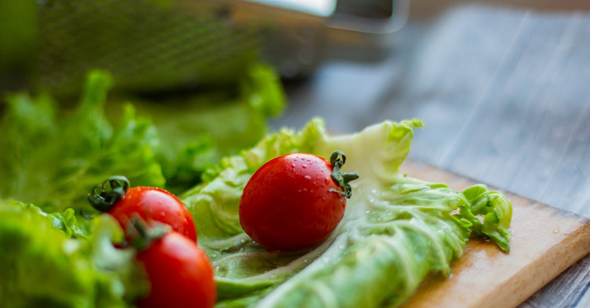 Other ways to preserve red cabbage [closed] - Cutting board with fresh salad leaves and tomatoes placed on table near grater