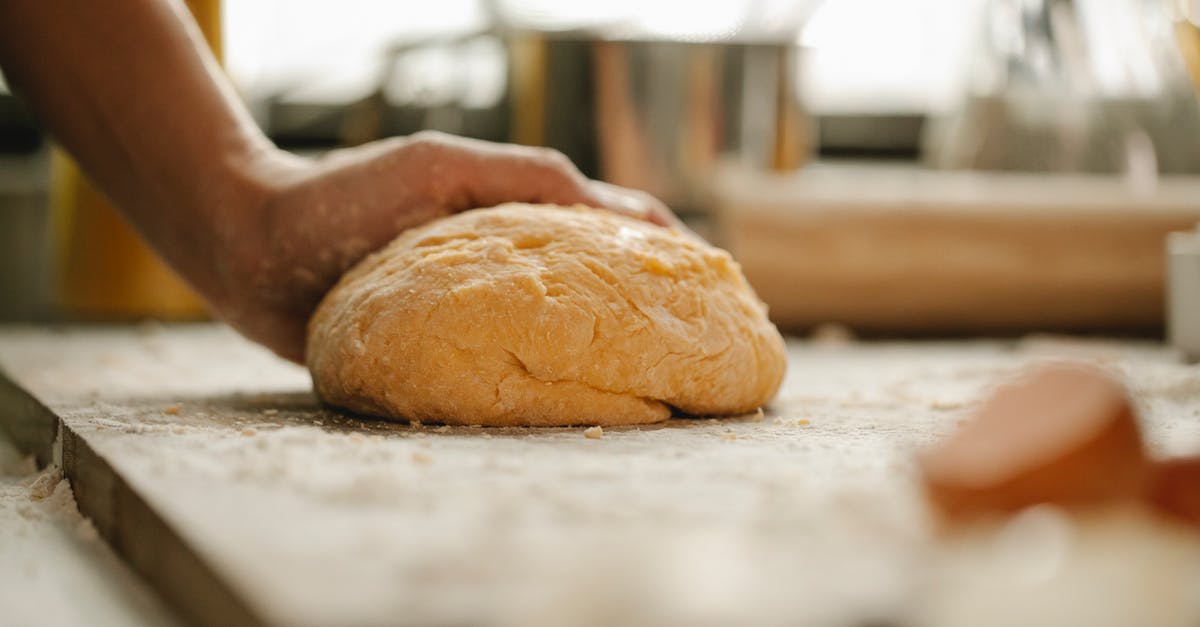 Overworking bread dough by hand - Chef making fresh dough in bakery