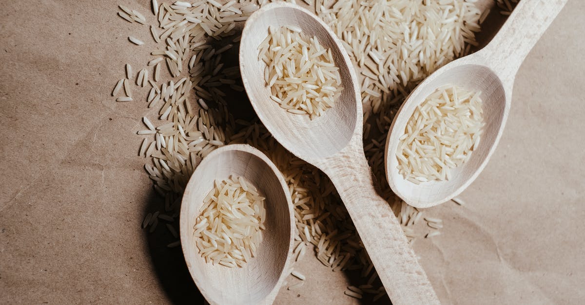 Oyama rice cooker - uncooked rice under heating element - A White Rice on a Wooden Spoons