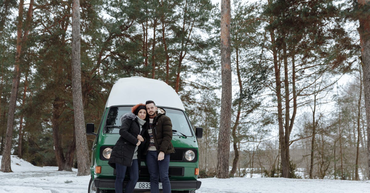 ozone and its impact on cold fermentation - Man and Woman Sitting on Green Van on Snow Covered Ground