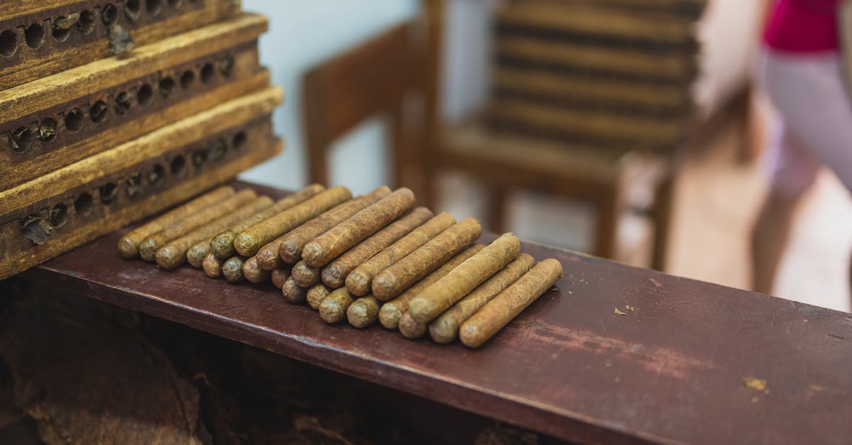 Packed meat unrefrigerated storage [duplicate] - Production of raw cigars on wooden table in fabric