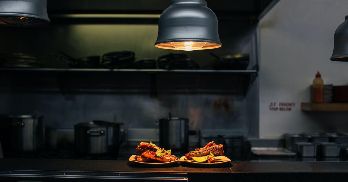 pan to bake a pound cake - Plates with sweet cakes under lamp in kitchen