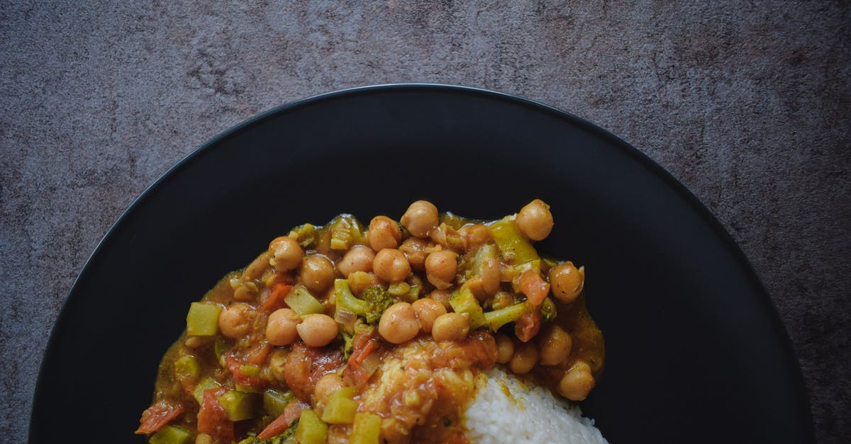 Parboiling potatoes to make them softer in a stew - Tasty rice with stewed vegetables on plate