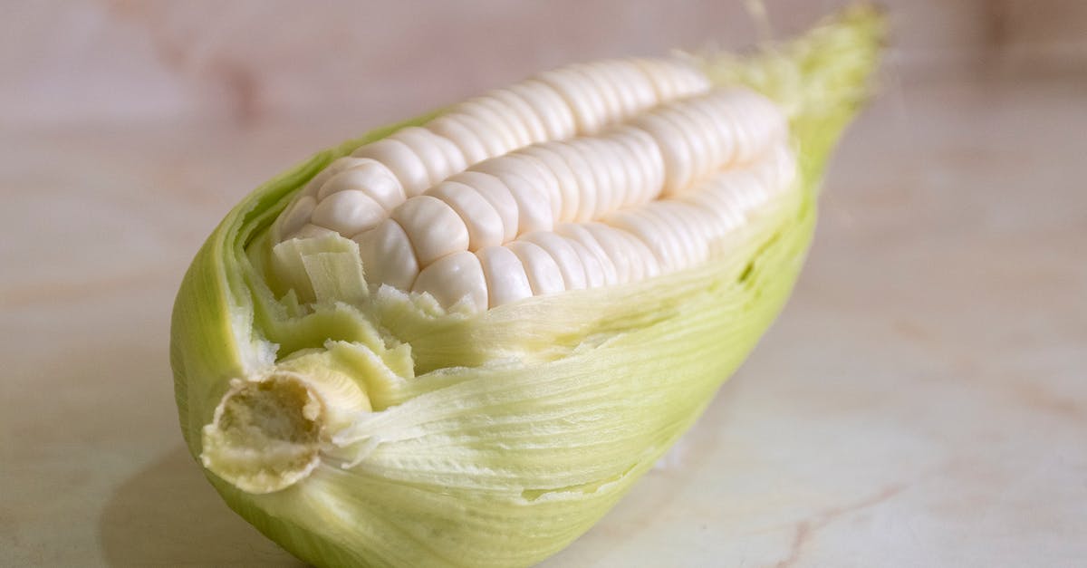 Par-Cooking Corn on the Cob in a Microwave - Yellow and Green Corn on Brown Wooden Table