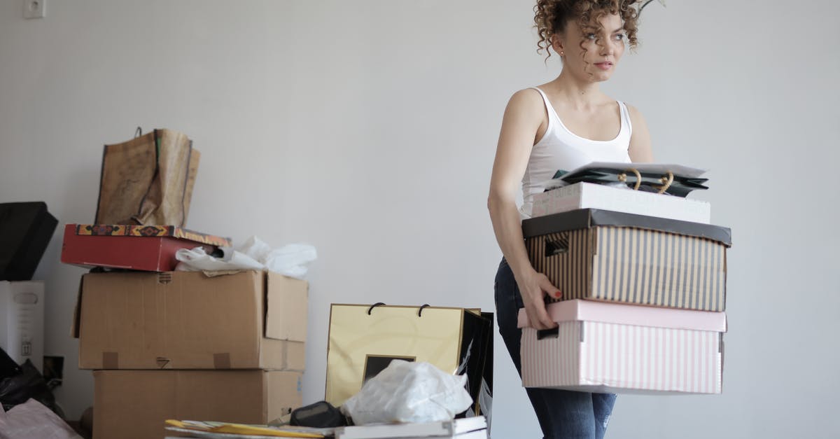 Parsley: flat-leaf or curly? - Concentrated woman carrying stack of cardboard boxes for relocation