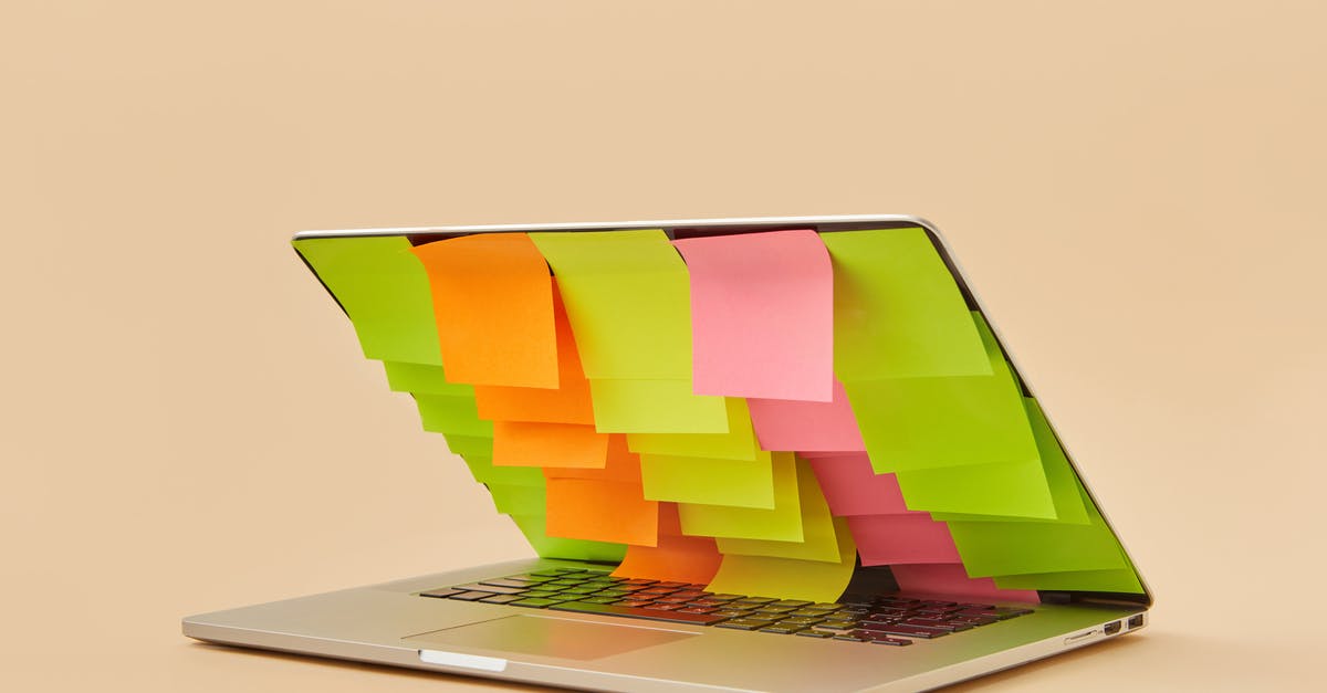 Partially defrosting, then refreezing? - An Arrangement of Blank Sticky Notes Covering the Screen of a Partially Closed Laptop