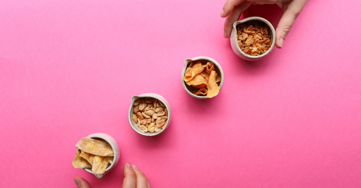 Peanut butter becomes dry - Crop people taking bowls with dried fruits