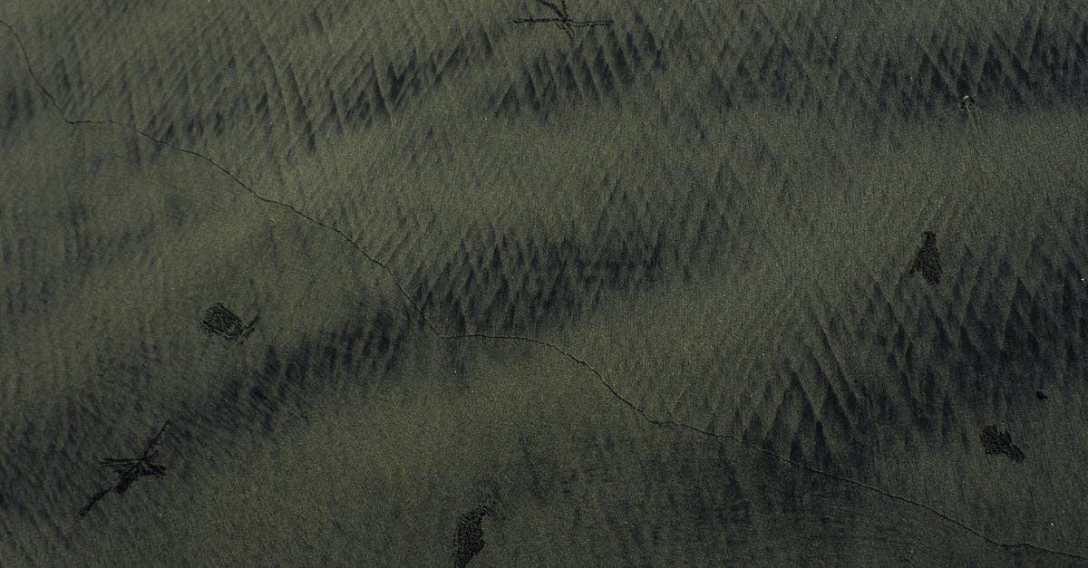 peeling black eyed peas for acaraje (fritters) - Abstract dark background with scratches