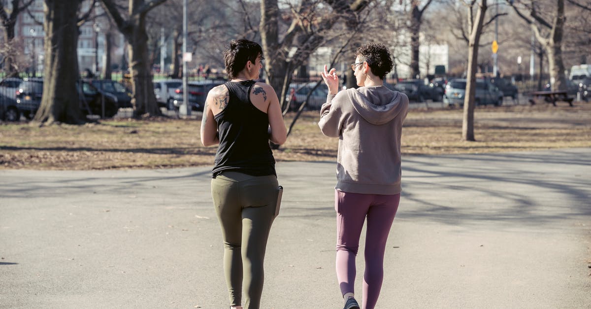 Physical method to season steaks - Fit sportswomen walking in sunny autumn park