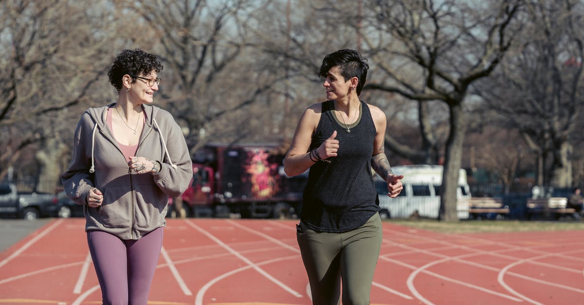 Physical method to season steaks - Young fit women jogging on stadium