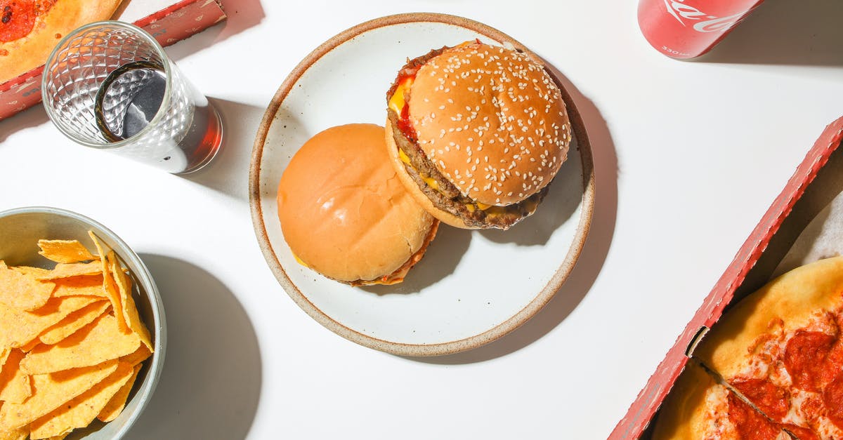 Pickle Accompanying Hotdogs, Burgers, Sandwiches in the US - Burgers on White Ceramic Plate