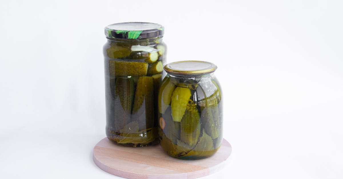 pickled cucumbers seemingly lasting "forever" - Two Clear Glass Jars Of Preserved Pickles On A Cutting Board