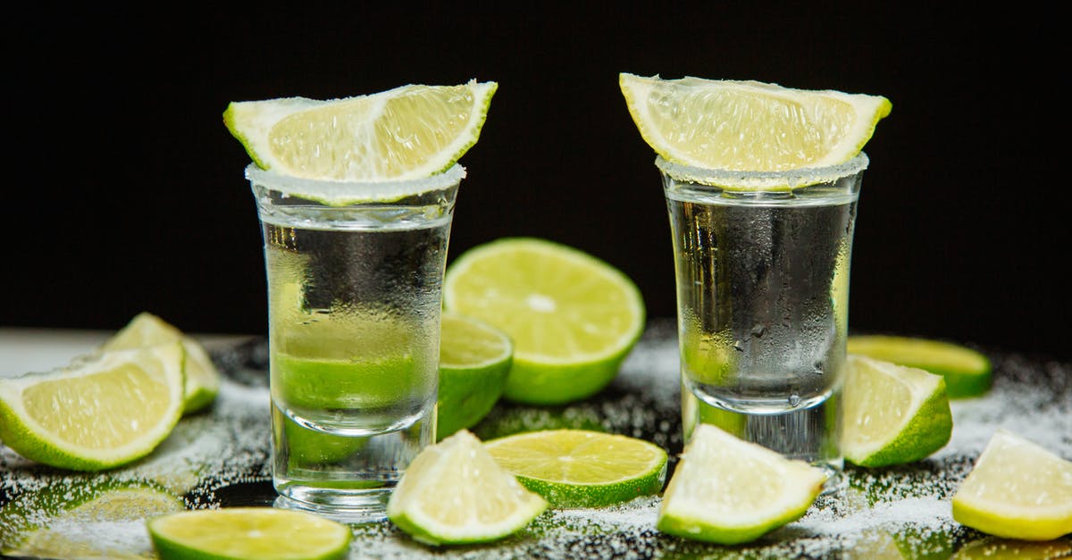 Pickled/preserved lemons/limes - grams of salt per kilogram of fruit? [duplicate] - Tequila Drink with Slices of Lime on the Top of Shot Glass