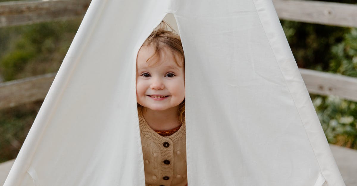 Pickles (cucumbers) came out a little soggy after canning - Happy little child smiling while peeking from tent