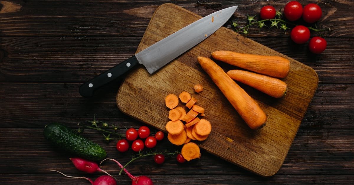 Pickling whole cucumbers - Sliced and Whole Carrots on Brown Wooden Chopping Board