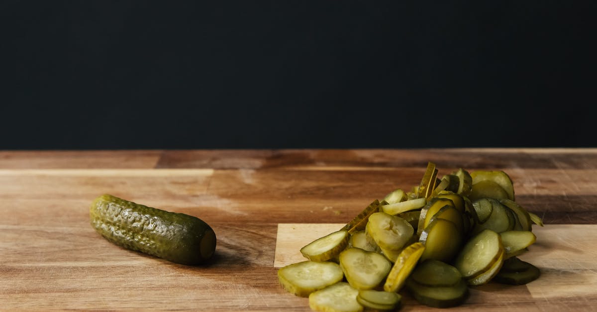 Pickling whole cucumbers - Delicious Fresh Pickles on a Wooden Chopping Board