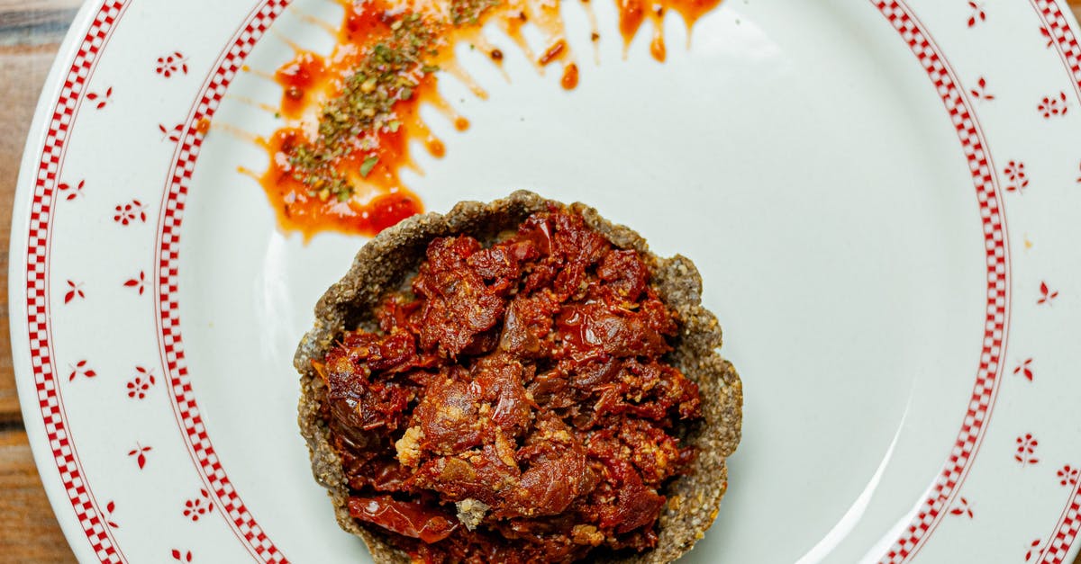 Pie Crust Partially Cooked - From above of appetizing vegetarian quiche with tomatoes and sauce on white plate