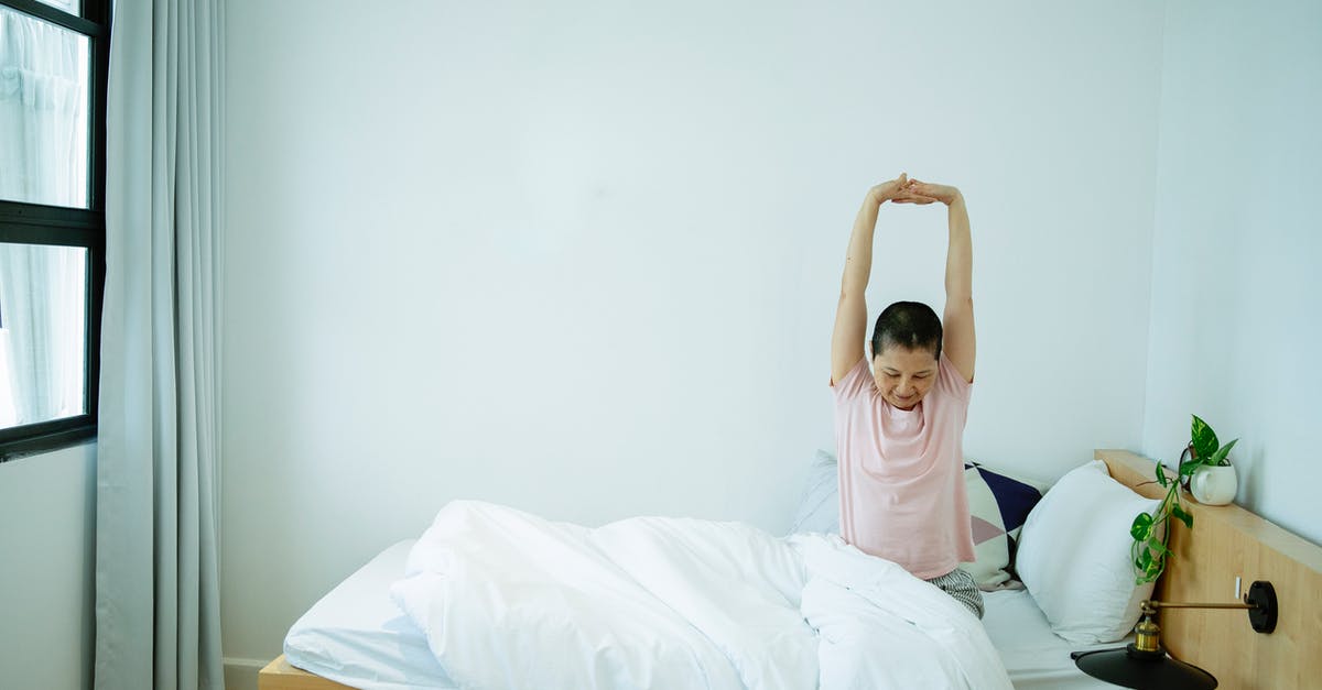 Pizza dough is too soft to stretch well - Ethnic female stretching body on bed in morning