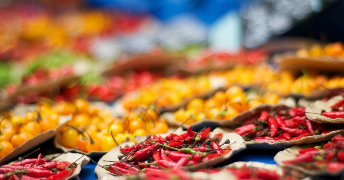 Please clarify confusion between chillies and pepper? [duplicate] - Selective Focus Photography of Bunch of Chilies