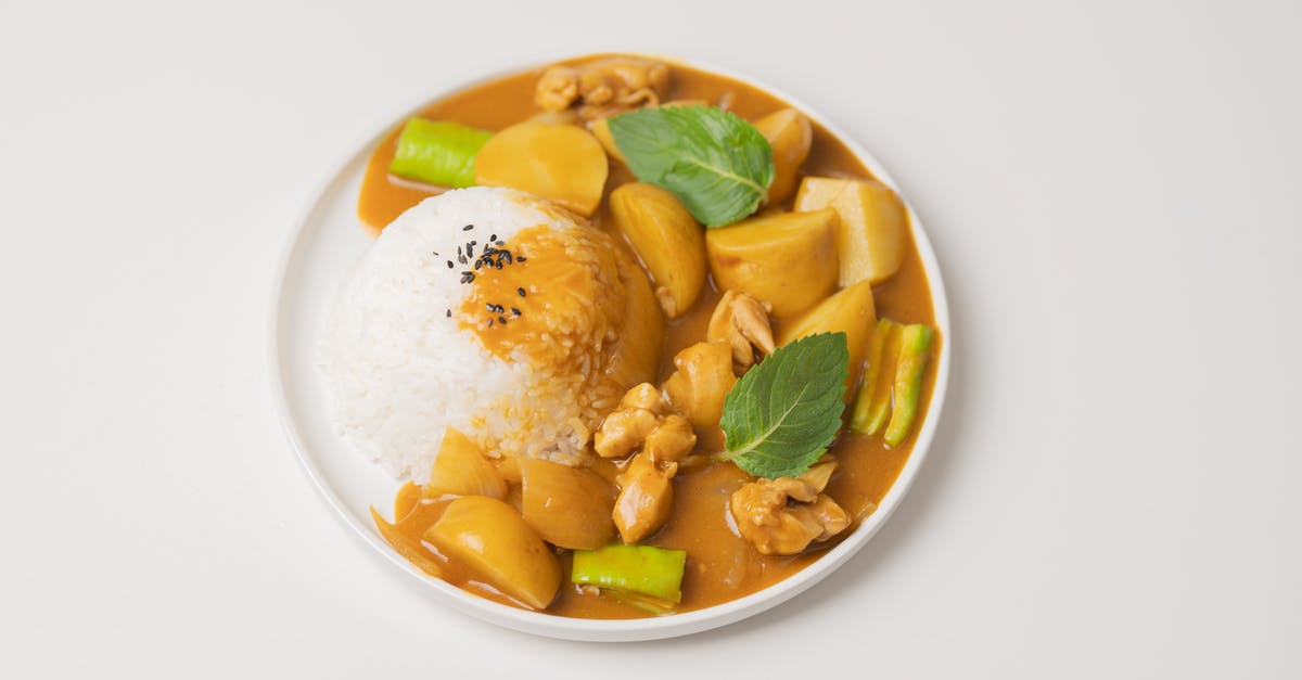 please help fixing my portugese sauce (a kind of korma-like non-spicy curry sauce served in hk and macau) - From above of appetizing dish of Indian cuisine curry made of vegetables and meat and served with rice and green leaves