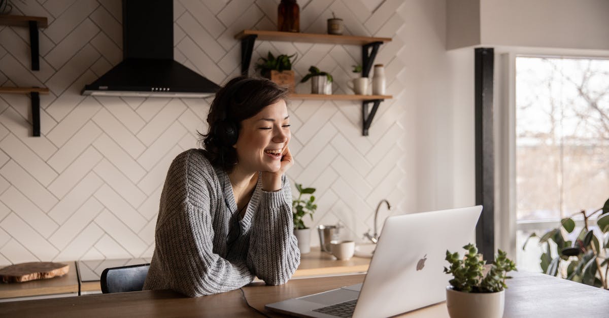 Please tell me what this kitchen tool is called and its use, specifically - Young cheerful female smiling and talking via laptop while sitting at wooden table in cozy kitchen