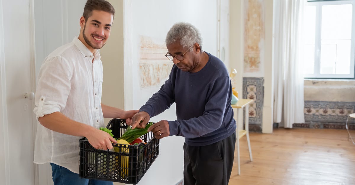 Possible dangers of home fermentation of vegetables - A Man Holding a Plastic Crater while Assisting an Elderly Man