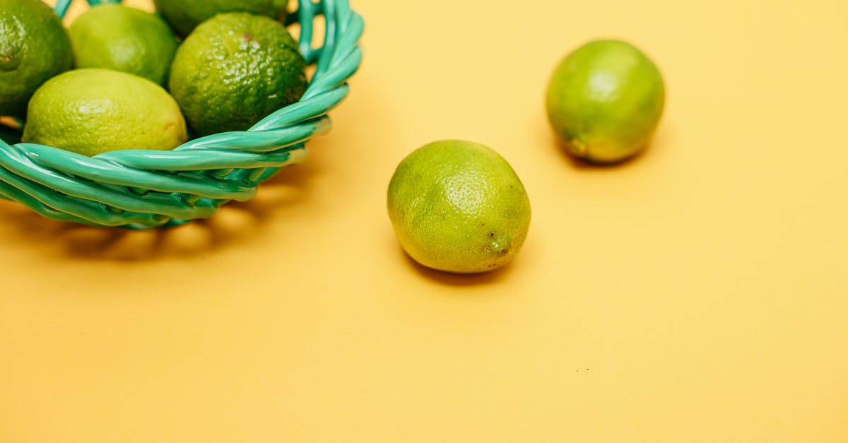 Post harvest treatment of organic limes vs conventional limes - Green Limes in a Green Woven Basket