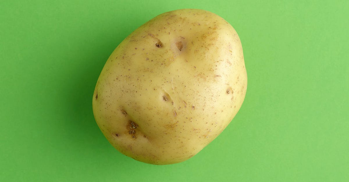 Potato in the microwave - White Round Fruit on Green Surface