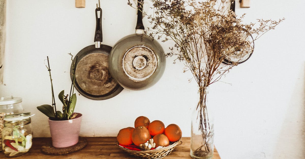 Pots and Pans in the dishwasher - Two Gray Frying Pans Hanging on Wall