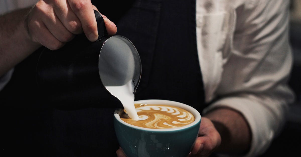 Pouring technic (coffee) - the difference between clockwise and counterclockwise pour [closed] - Close-Up Photo of Man Pouring Milk In Coffee