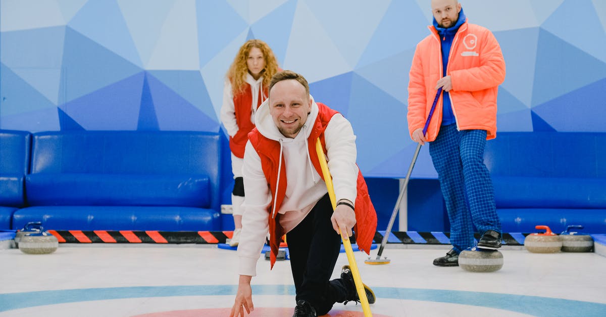 power outage/frozen meat - Cheerful sportsman playing in curling in ice rink