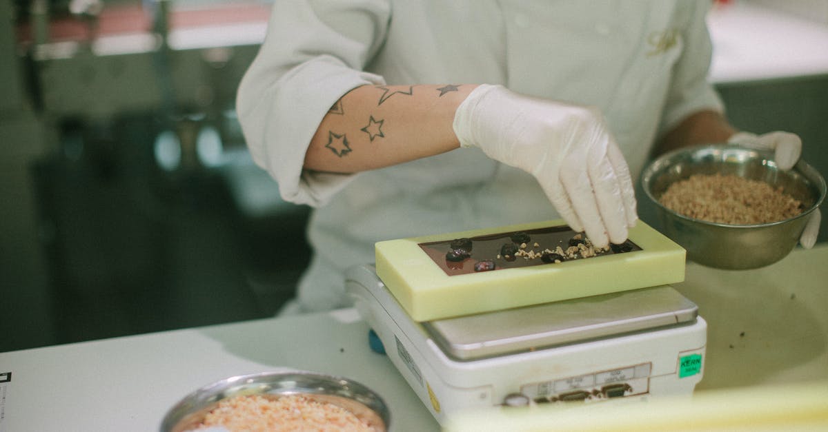 Precautions making carpaccio - Person in White Chef Uniform Holding White and Green Plastic Container