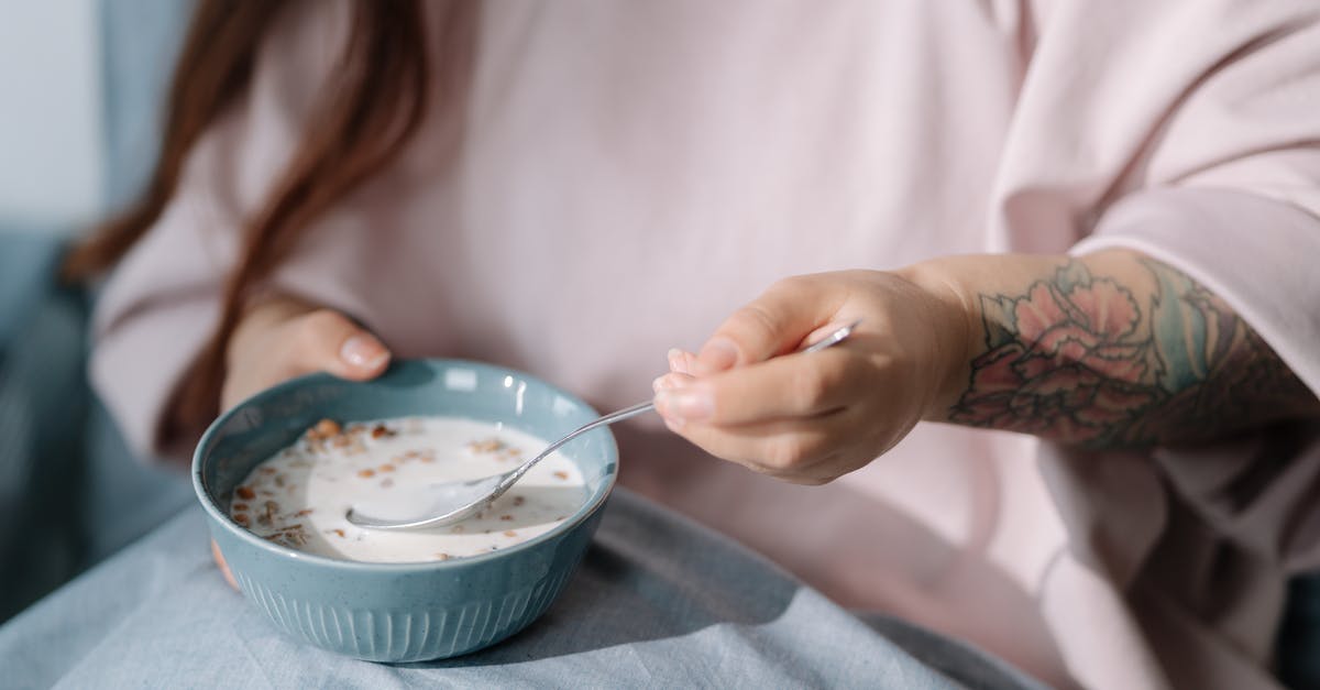 Premixed Bircher muesli (cereal) - soak overnight or ready-to-eat? - Woman eating cereal with milk