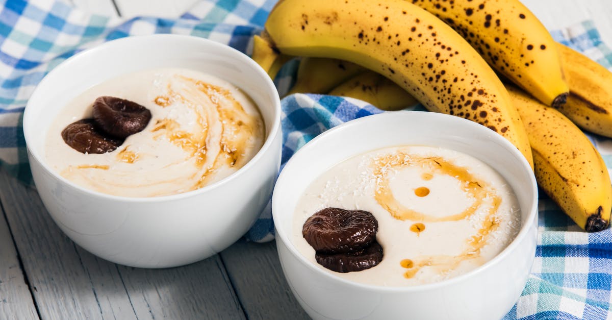 Premixed ingredients for yogurt - Bananas Beside Two White Bowls with Heavy Cream