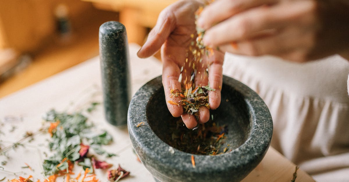 Preparation of gravlax versus lox - Women Preparing Dry Herbs in Mortar and Pestle