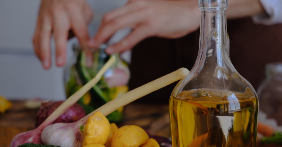 Preparation of gravlax versus lox - Clear Glass Bottle With Yellow Liquid