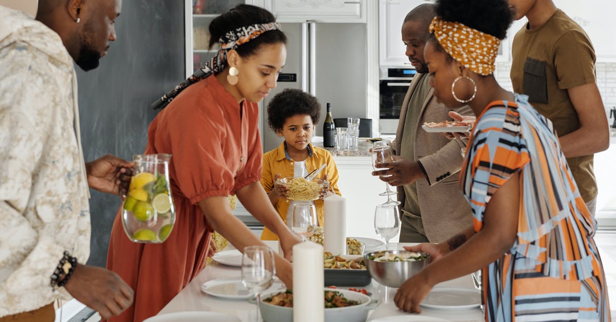 Preparing dishes for photos - Family Setting the Table for Dinner