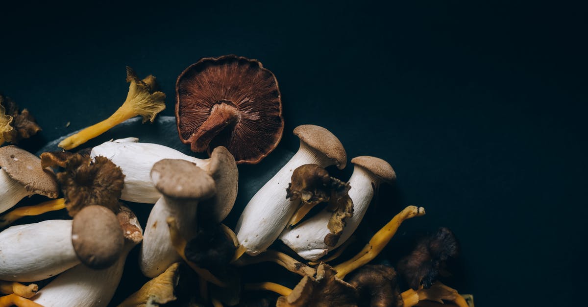 Preparing dried mushrooms for risotto [duplicate] - Brown and White Mushrooms in Black Surface