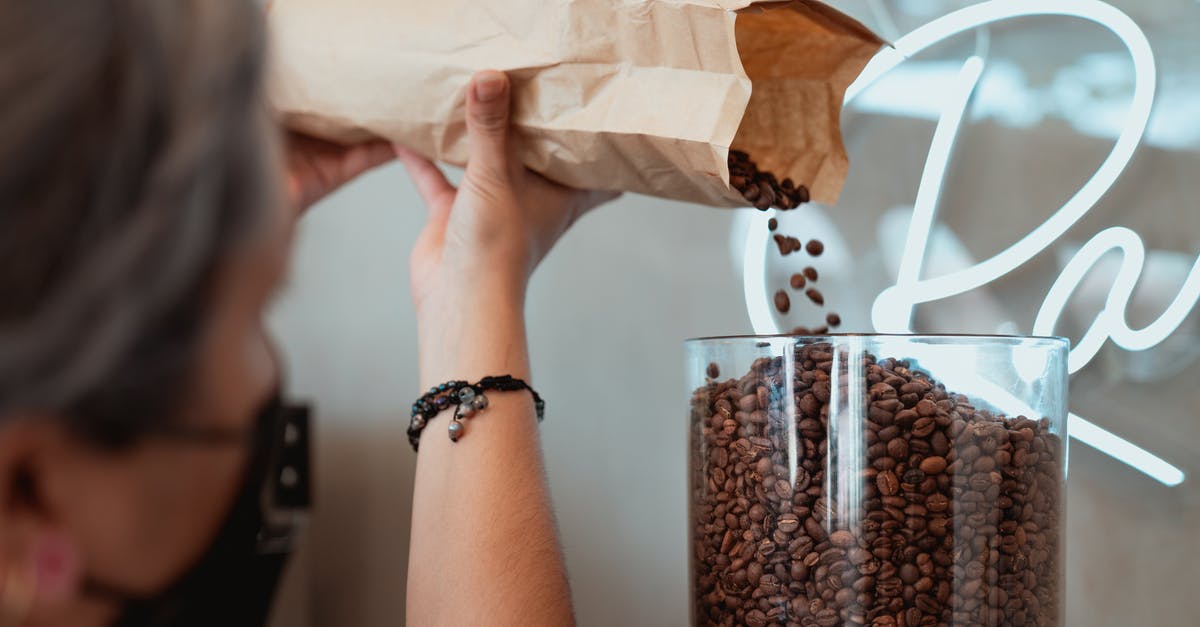 preparing lupini beans? - Photo of Barista Pouring Fresh Coffee Beans on Coffee Grinder