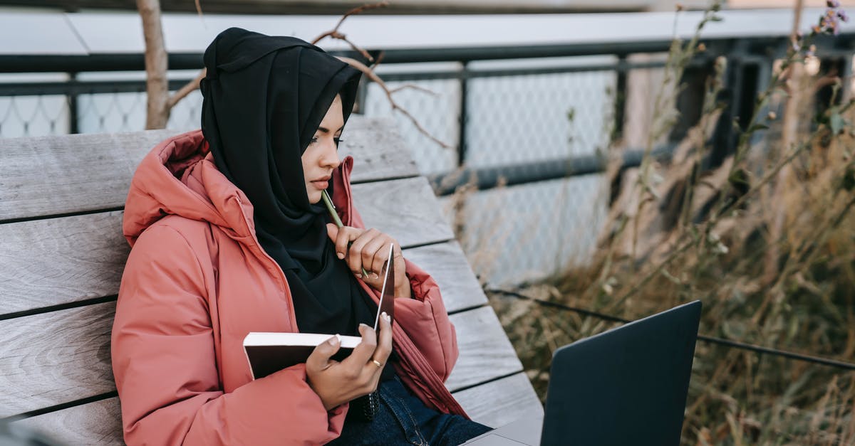 Preparing Meats using Dry Rubs - Ethnic lady using computer in street