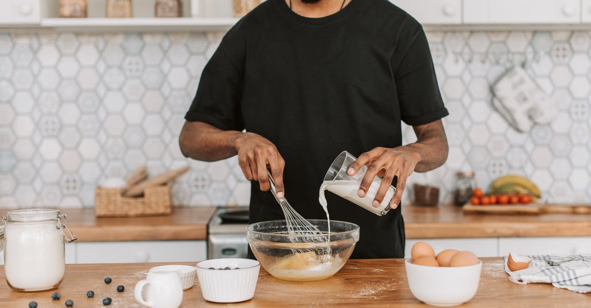 Preparing soy milk at home - 
A Man in a Black Shirt Pouring Milk on a Bowl