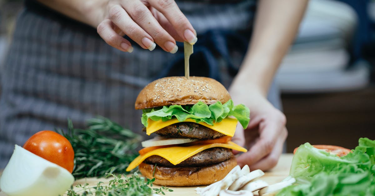 Preserve crustiness/freshness of toasted bread - Crop woman with burger in kitchen