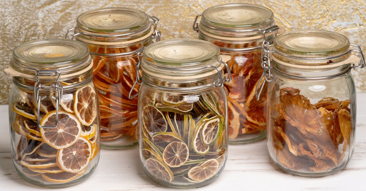 Preserved lime is browning and fading inside the brine - Dried Fruits in Glass Jars