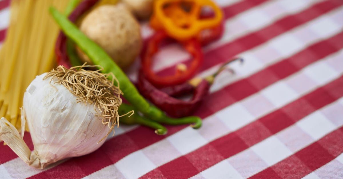 Preserving colour of vegetables in Chinese hakka noodles - Garlic on Red and White Gingham Textile