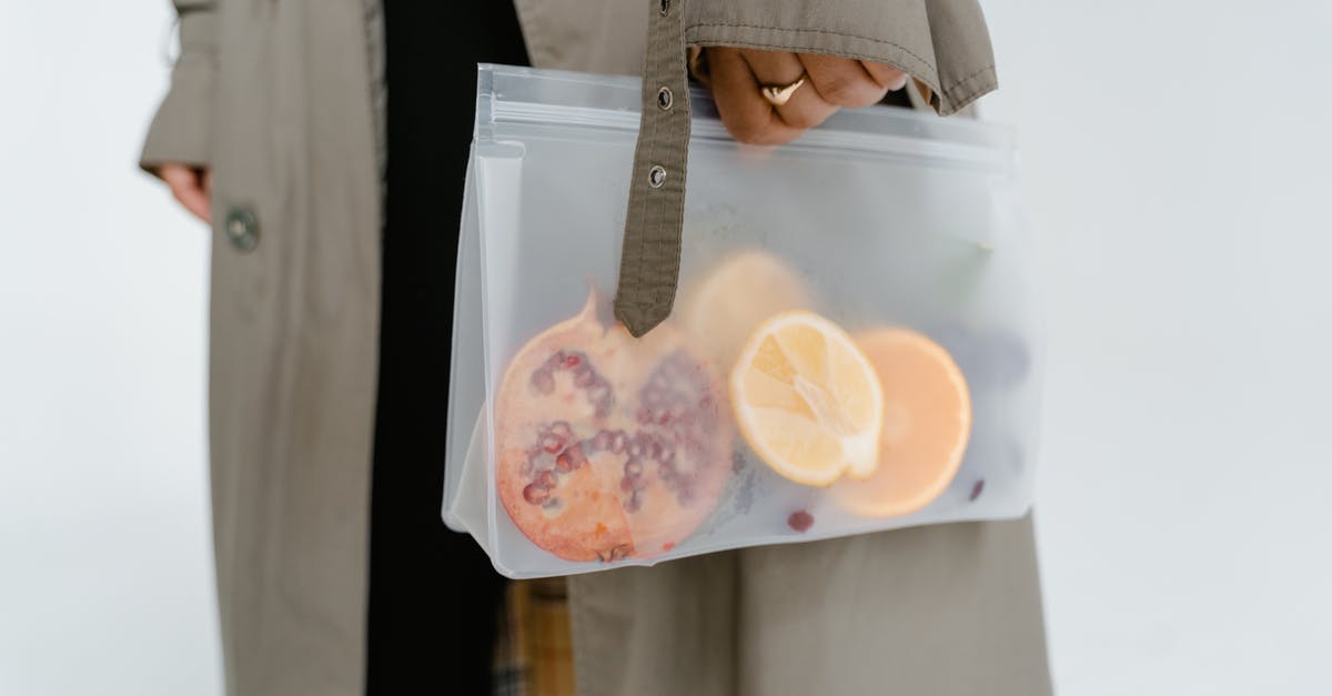 Preserving dehydrated fruits and vegs - A Person Holding Fruits in a Zip Lock Bag

