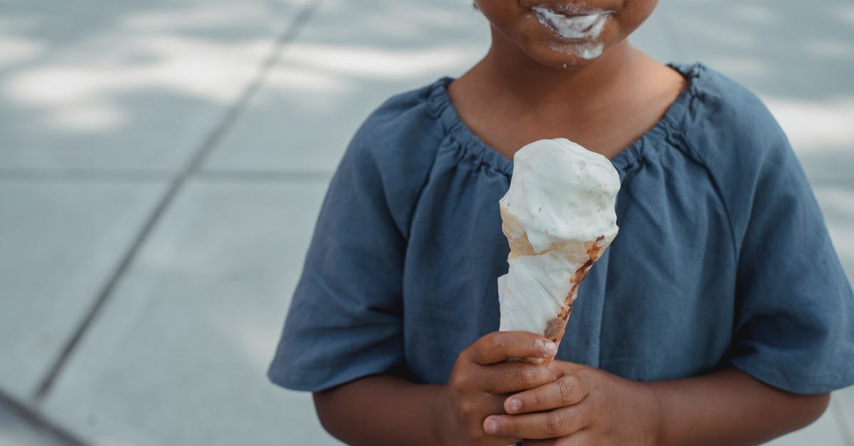 Preserving Nerds / Pop Rocks so they activate in the mouth and not in the food - Little child with dirty mouth standing with ice cream on street