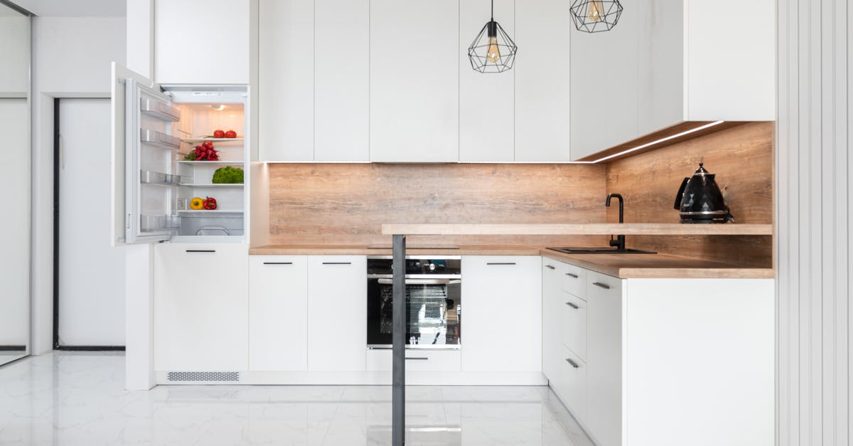 Preserving vegetables in the fridge - Interior of contemporary light kitchen with white furniture and modern appliances