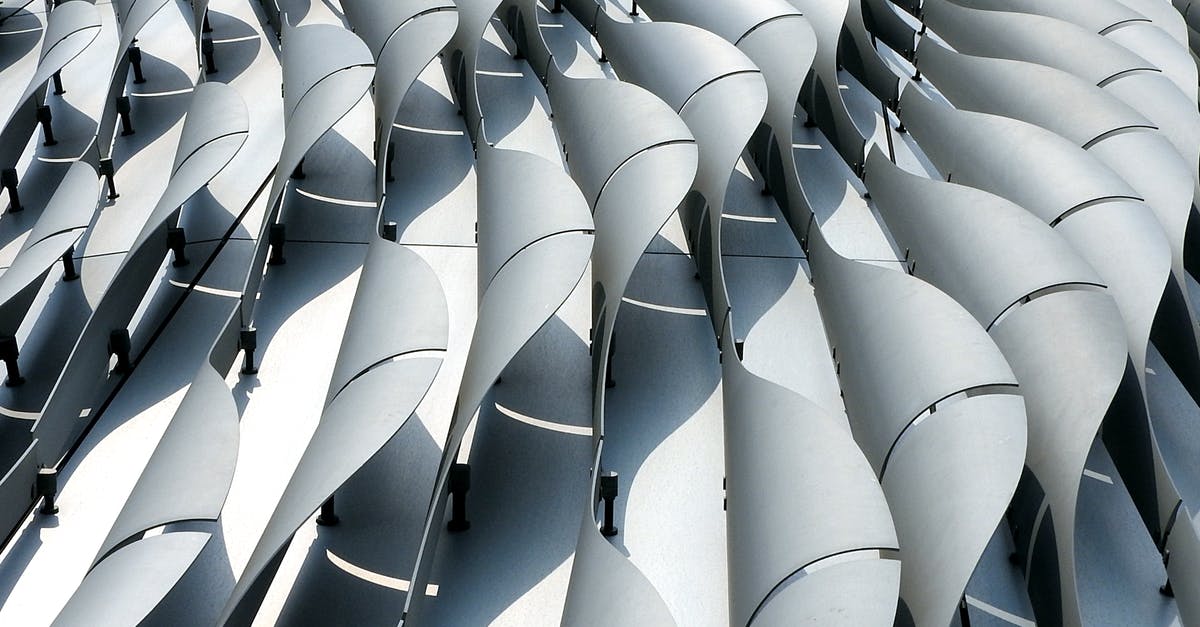 Prime Rib versus New York Strip Roast - Curved ribs of gray color on wall of futuristic building shining in daylight